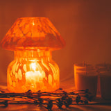 mushroom candle lamp refills next to lit lava candle lamp.