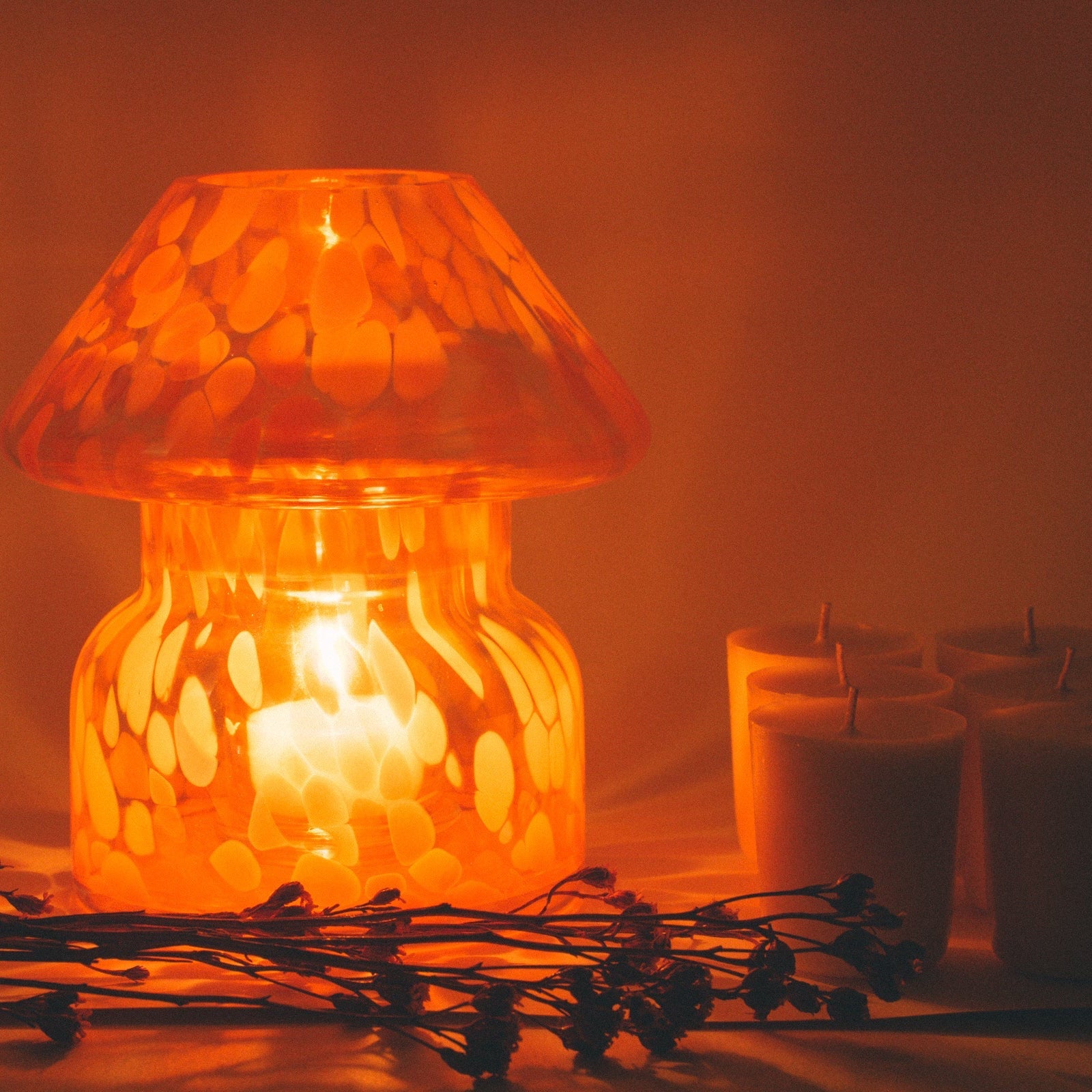 mushroom candle lamp refills next to lit lava candle lamp.