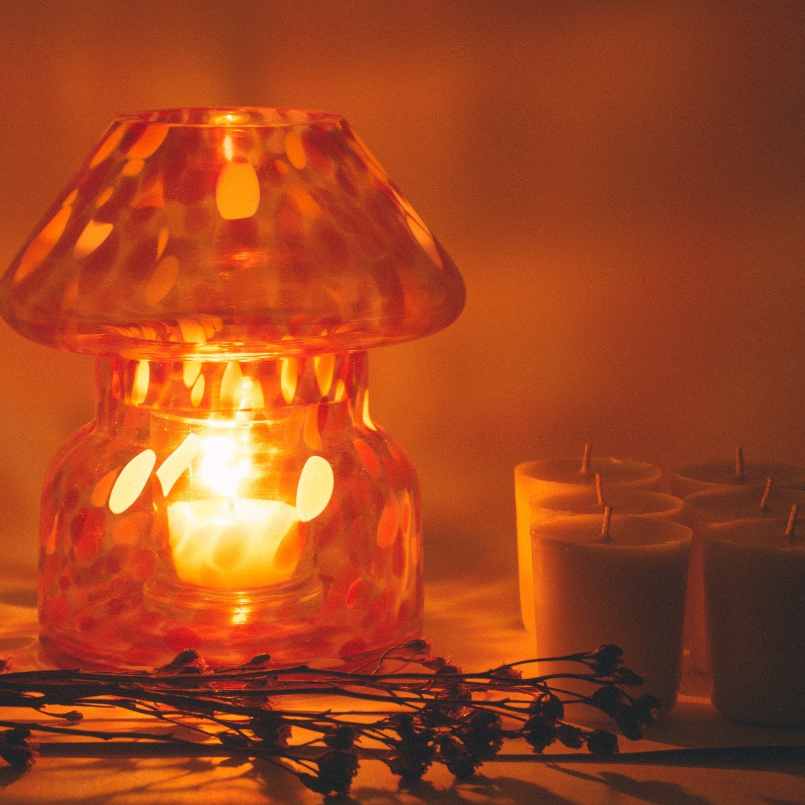 mushroom candle lamp refills next to lit retro candle lamp.