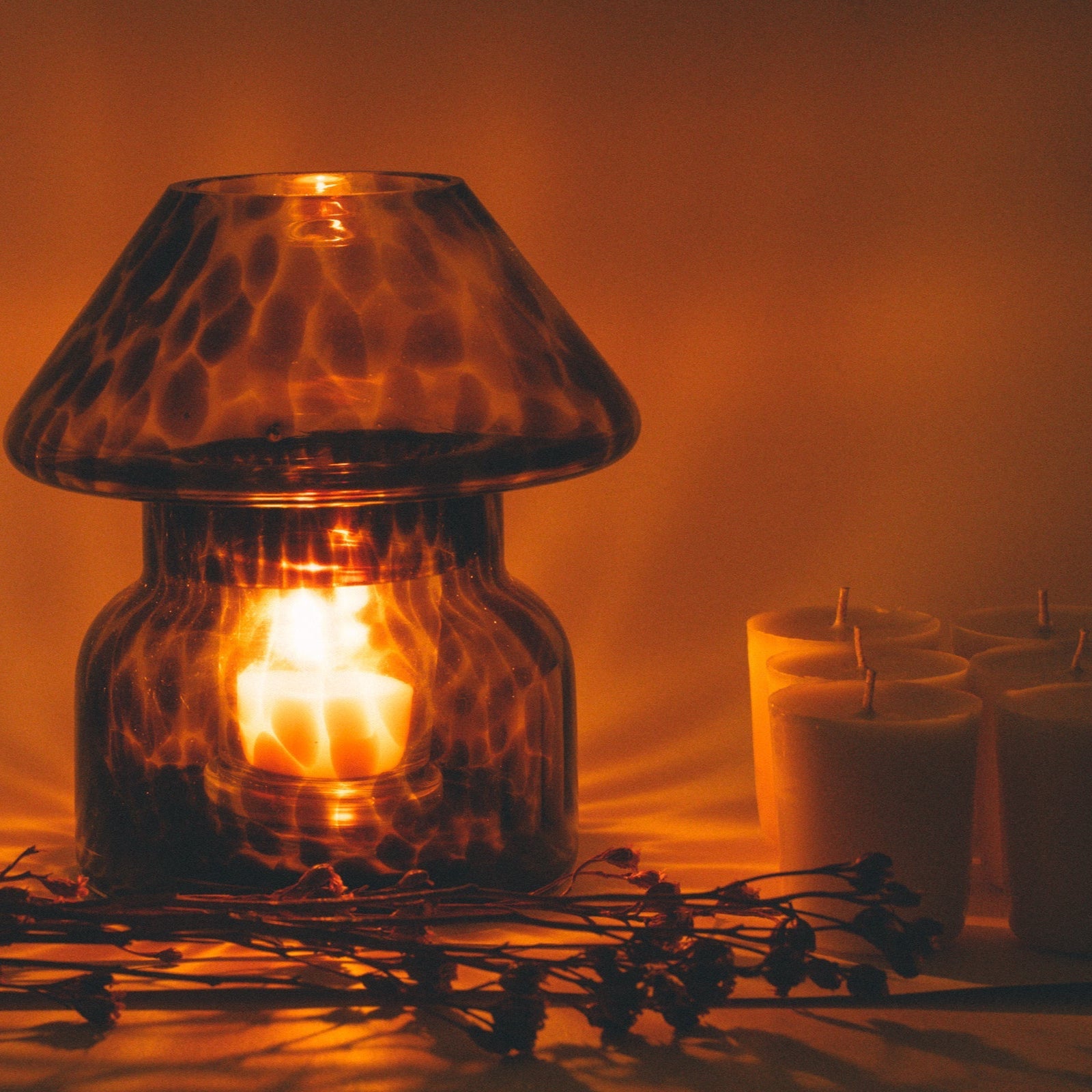 mushroom candle lamp refills next to lit leopard candle lamp.