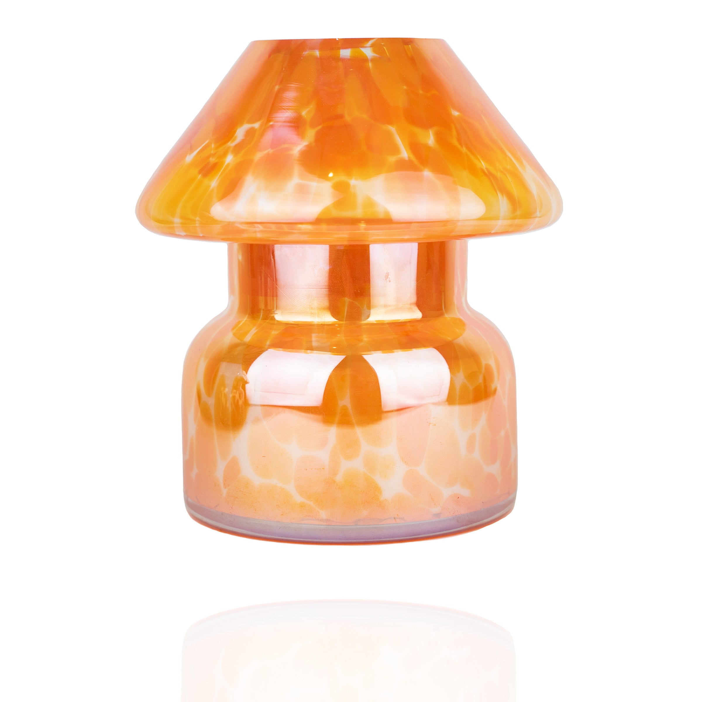 Mushroom candle lamp with light and dark orange spots on clear glass with opal tint. Filled with 100% soy wax.