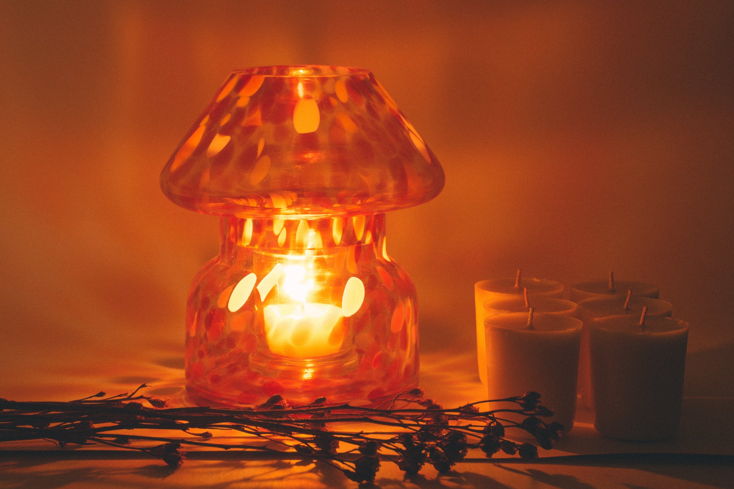 mushroom candle lamp refills next to lit retro candle lamp.