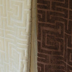 Close-up of textured beige and brown towel with geometric patterns.