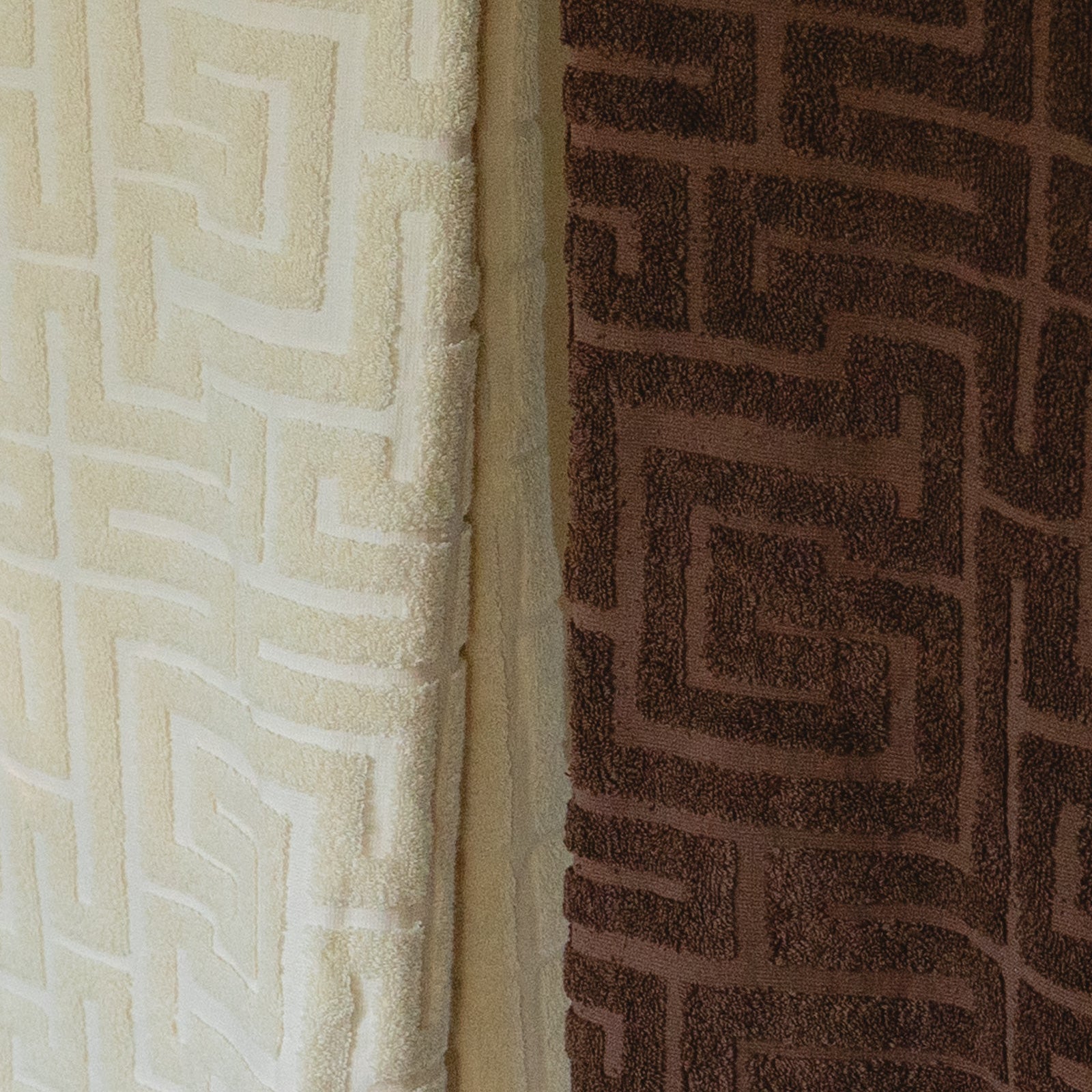 Close-up of textured beige and brown towel with geometric patterns.