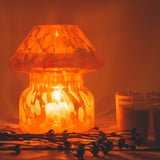 mushroom candle lamp refills next to lit lava candle lamp.