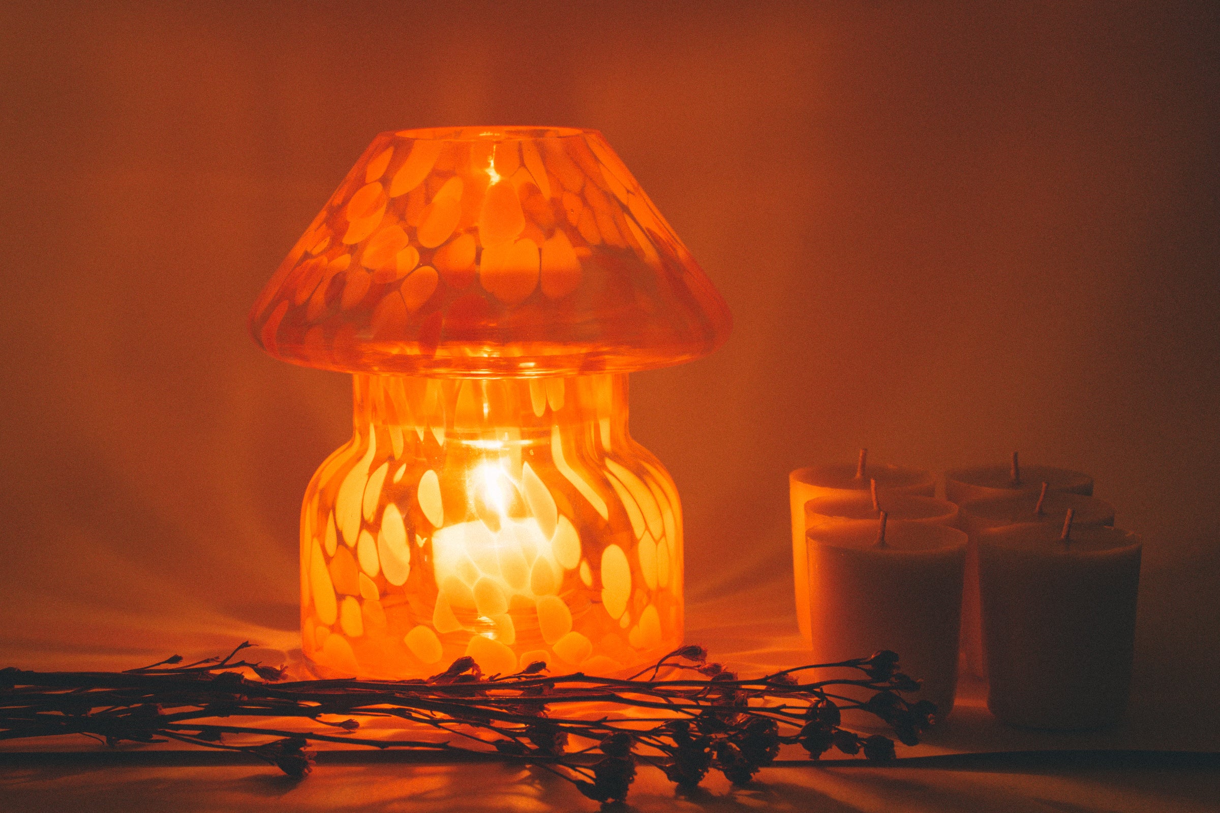 mushroom candle lamp refills next to lit lava candle lamp.