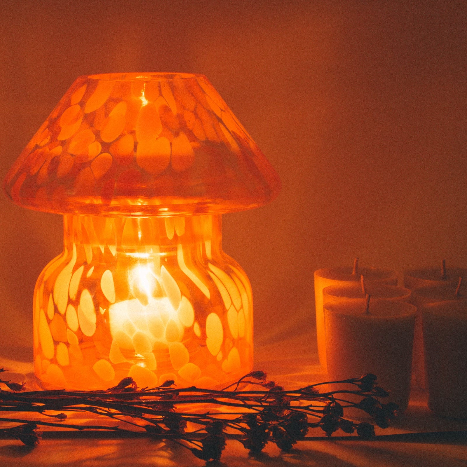 mushroom candle lamp refills next to lit lava candle lamp.