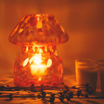 mushroom candle lamp refills next to lit retro candle lamp.