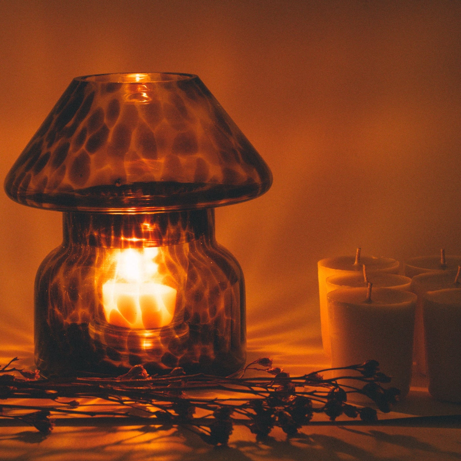 mushroom candle lamp refills next to lit leopard candle lamp.