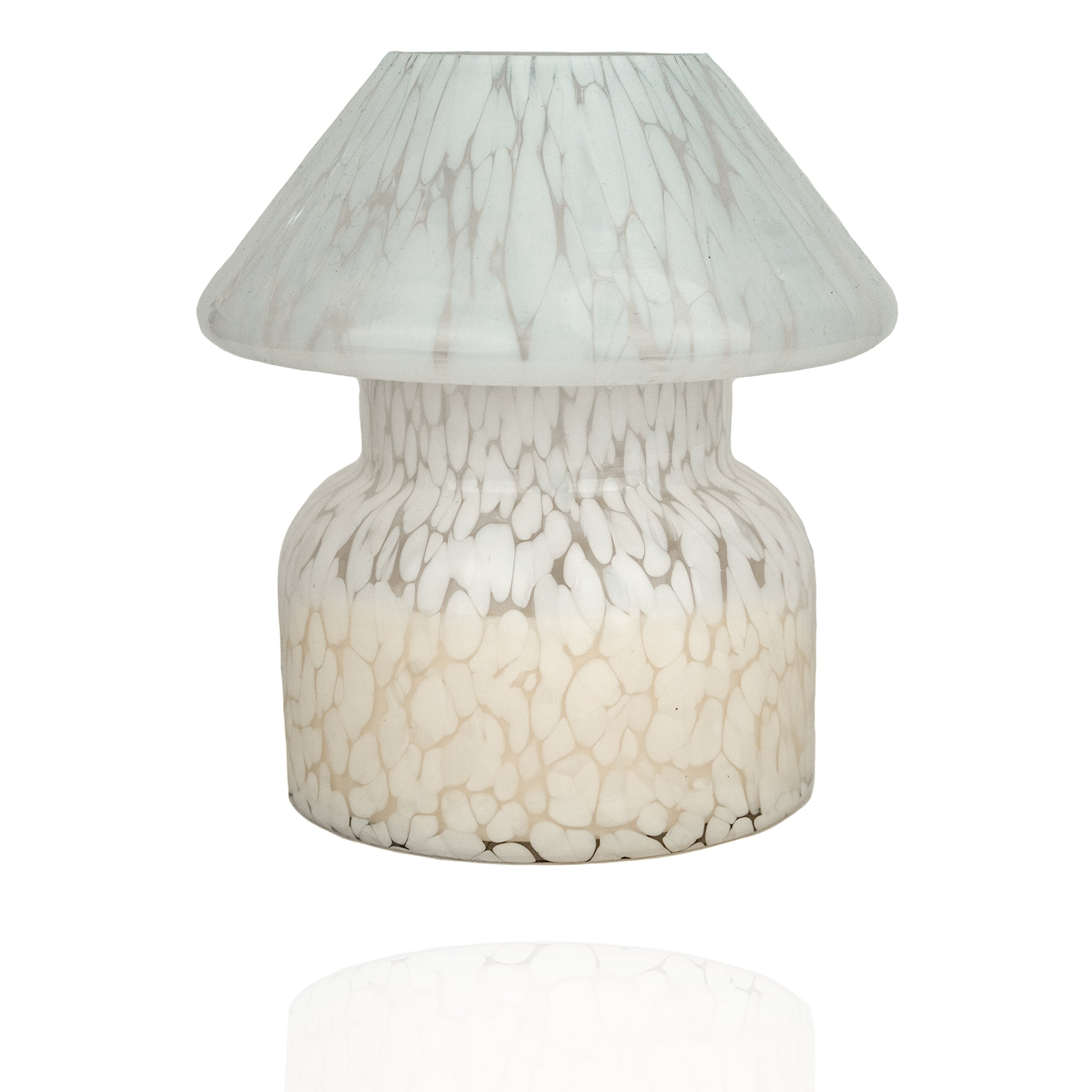 Mushroom candle lamp with white spots on clear glass. Filled with 100% soy wax.
