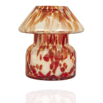 Mushroom candle lamp with red, orange and white spots on clear glass. Retro lamp is filled with 100% soy wax